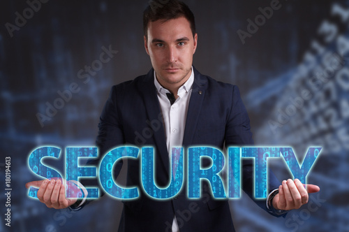 The concept of business, technology, the Internet and the network. Young businessman showing inscription: Security