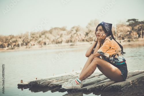Sad woman sit side river,she broken heart from love,breakheart girl concept photo