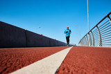Mature sportsman having morning workout along racetrack or urban road