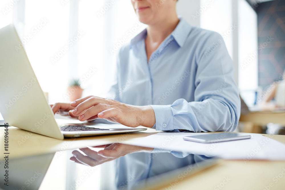 Mobile office worker typing on laptop keypad while working with online data Mobile office worker typing on laptop keypad while working with online data