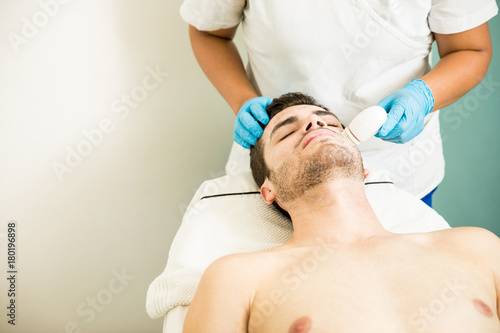 Man getting a facial exfoliation