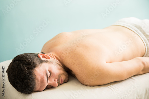 Man lying on a massage bed