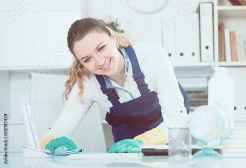 Cheerful female cleaning furniture