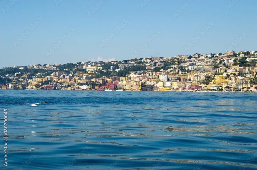 View from the sea of Posillipo hill, Naples and the blue waters of the Gulf of Naples