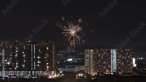 Celebration with firework over Asian suburb