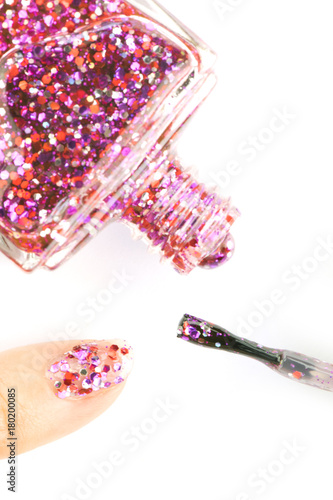 glitter pink nail polish on a white background.
