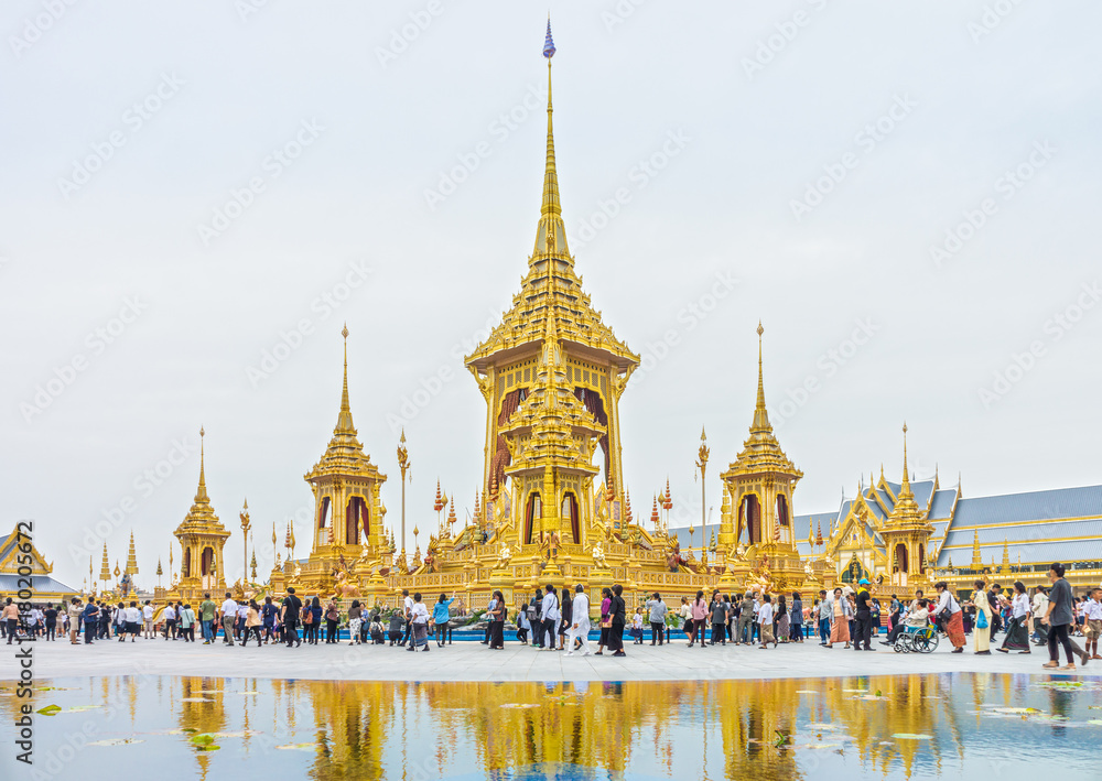 Naklejka premium Visitors tour around The Royal Crematorium for His Late Majesty King Bhumibol Adulyadej, Rama IX. Royal Cremation Exhibition is at Sanam Luang and remains open until Nov 30.