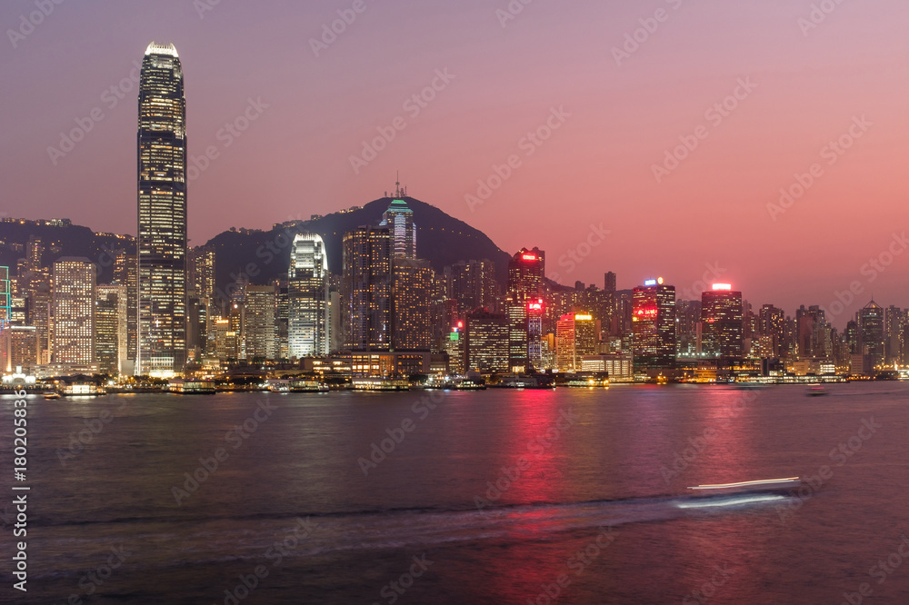 Fototapeta premium Hong Kong cityscape at twilight, long exposure photography for boat movement
