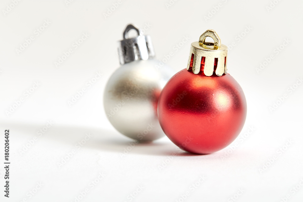 red and silver christmas bauble on a white red and silver christmas bauble on a white