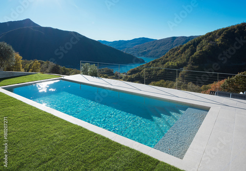 Modern swimming pool with lake and valley view