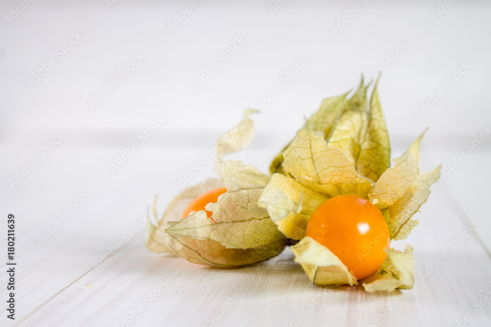 Exotic berries physalis on a white wooden table. Exotic berries physalis on a white wooden table.