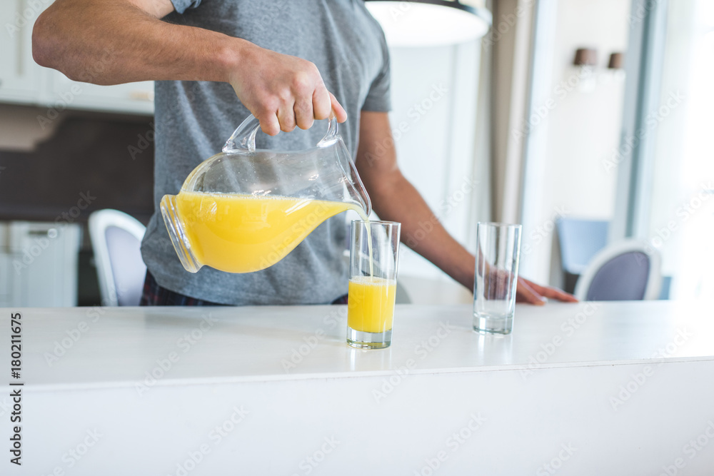 man pouring orange juice man pouring orange juice