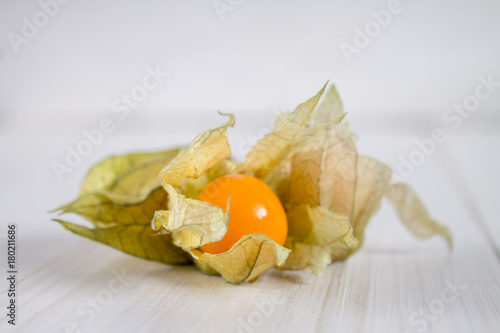 Exotic berries physalis on a white wooden table. photo