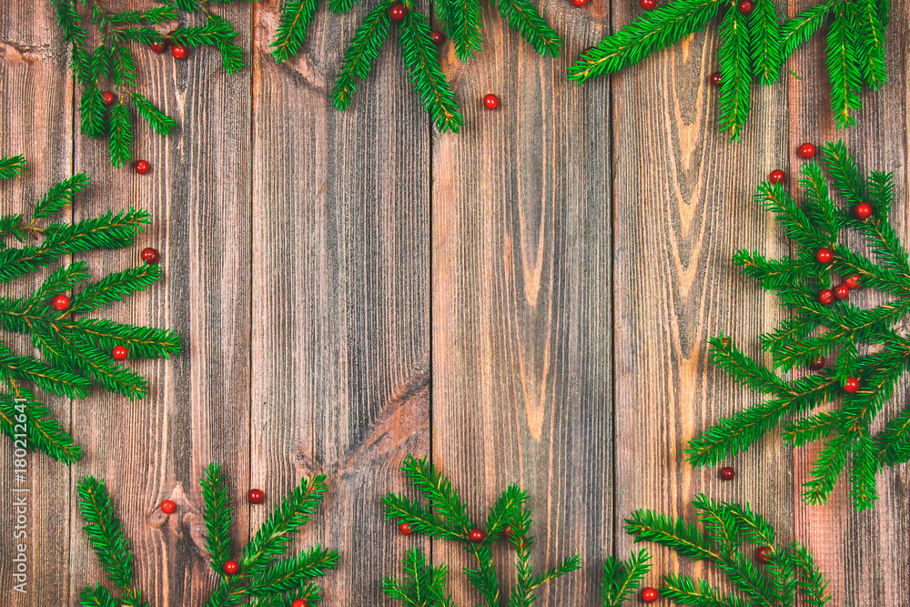 Spruce branches with red berries on a wooden table. copy space. Spruce branches with red berries on a wooden table. copy space.