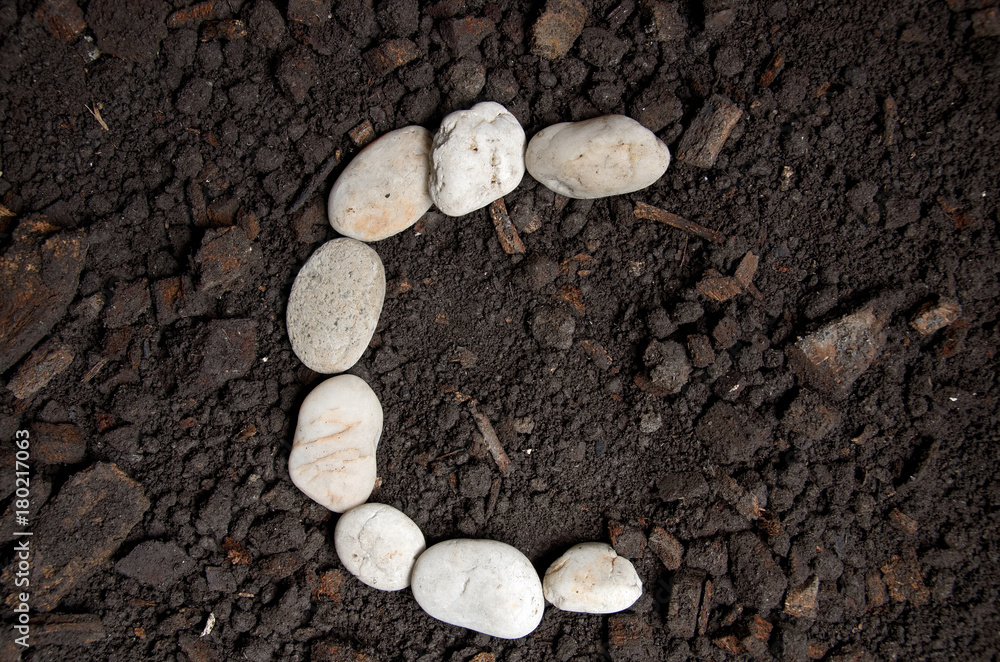 English alphabet (C - alphabet) from the white rock on the soil English alphabet (C - alphabet) from the white rock on the soil