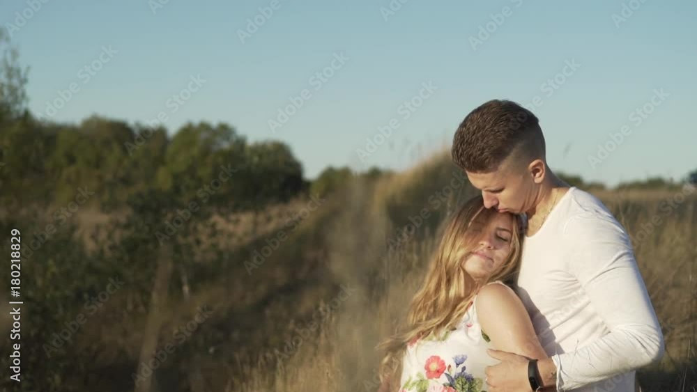 guy and girl are sitting on the grass on a sunny day guy and girl are sitting on the grass on a sunny day