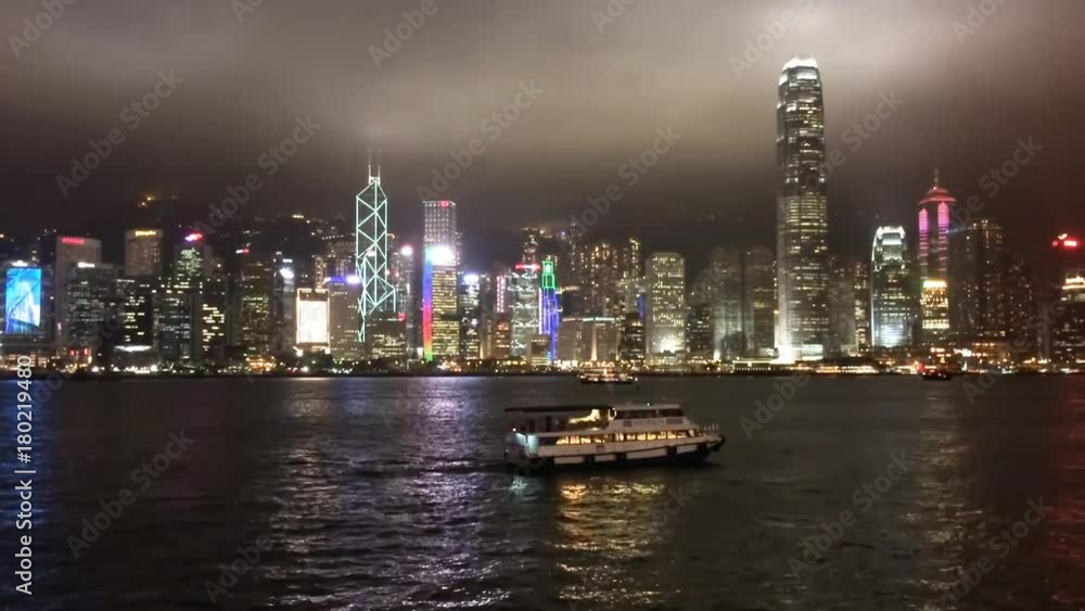 HONG KONG - APRIL 2014: City night lights with river reflection. Hong Kong attracts 10 million tourists annually. HONG KONG - APRIL 2014: City night lights with river reflection. Hong Kong attracts 10 million tourists annually.