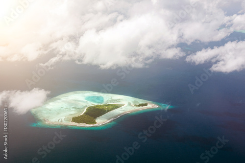 Tropical islands and atolls in Maldives in Indian Ocean from aerial view. Piece of paradise on the Earth. Good choice for vacation. Beautiful top view for wallpaper. © ViDi Studio