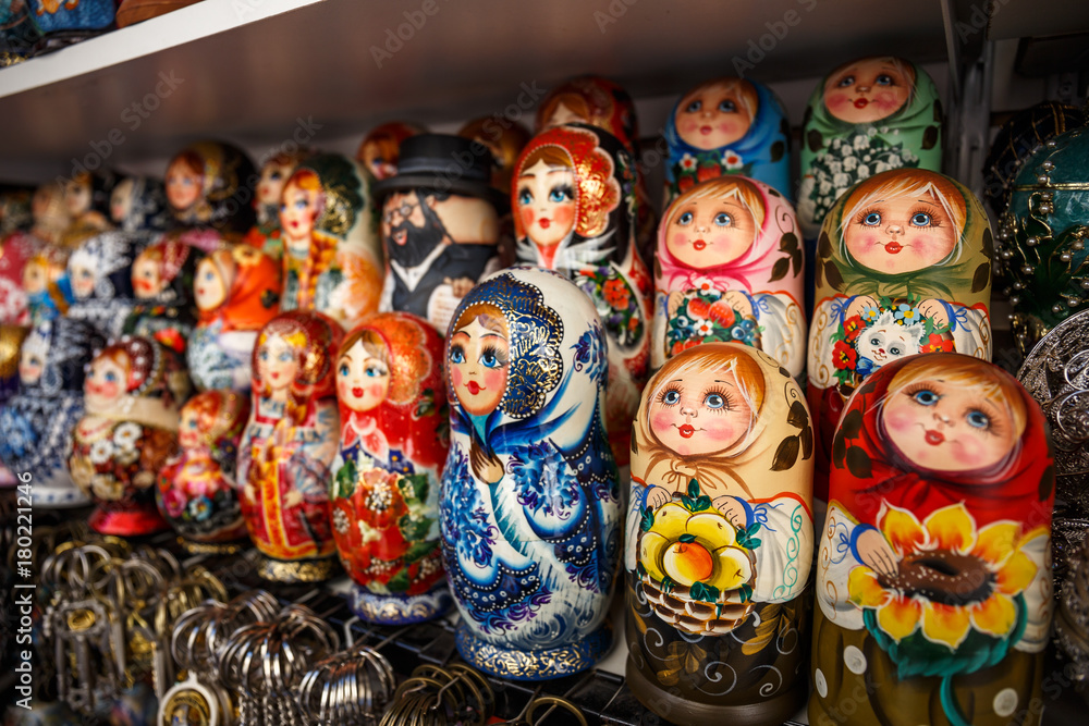Group of Russian souvenir Matryoshka on store shelf - wooden toy in the form of a painted doll