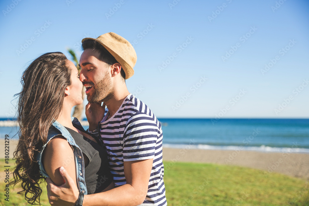 Young happy couple kissing outside