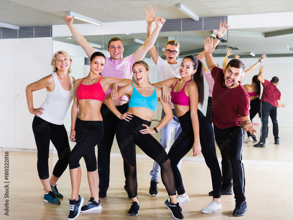 happy people posing in fitness studio
