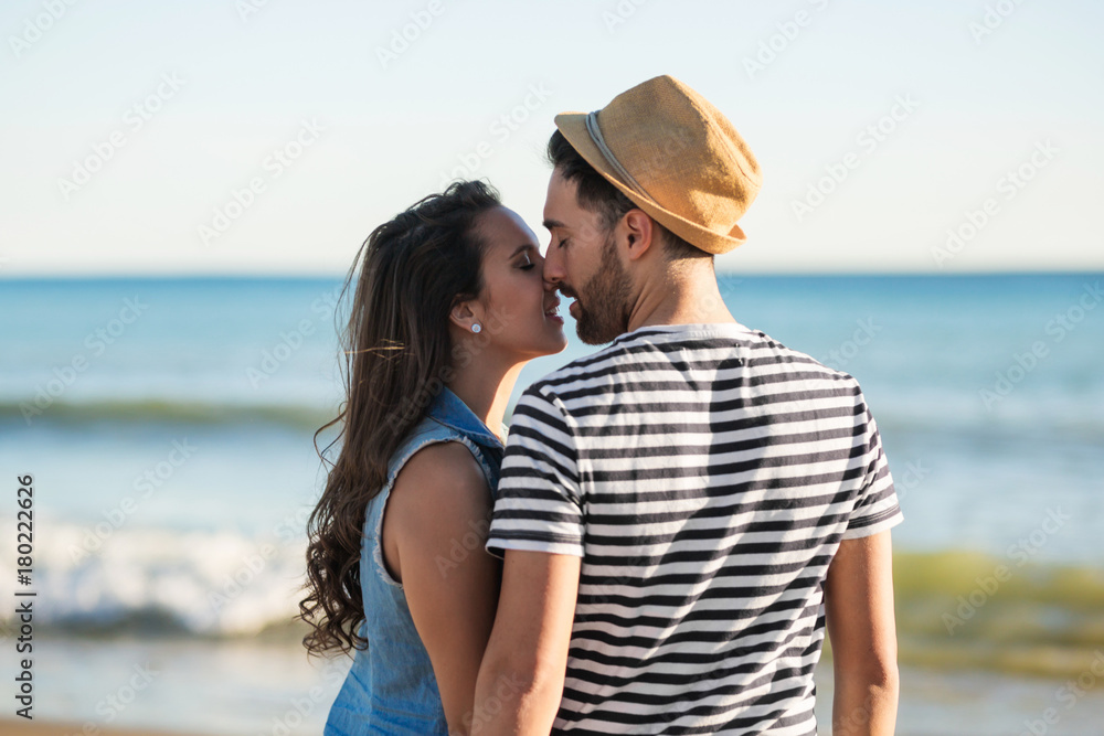 Couple standing at seaside kissing