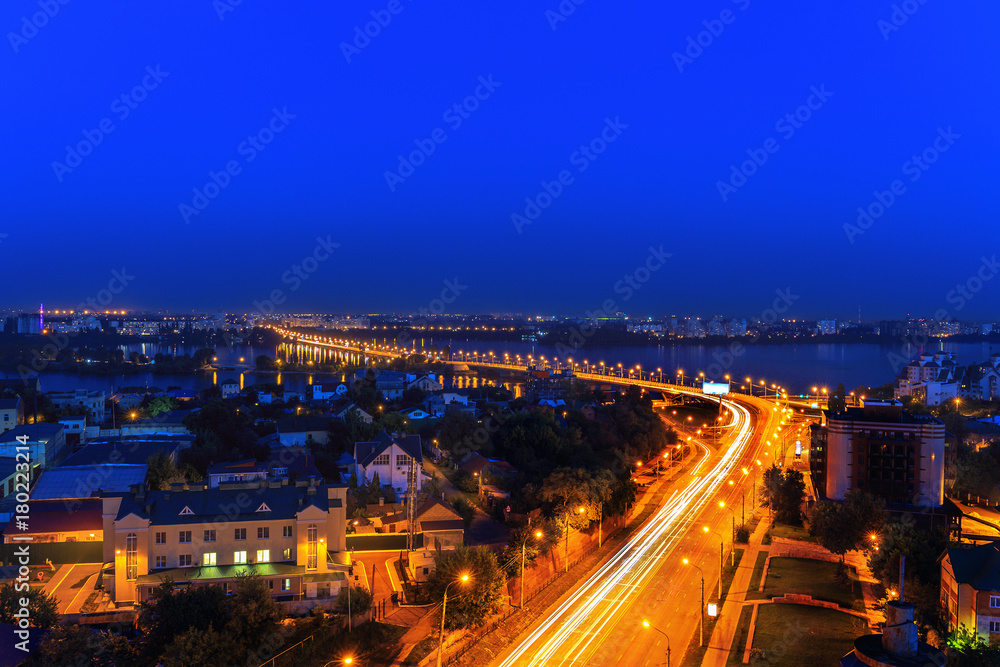 Aerial panoramic view to the center or downtown of  night Voronezh city, Russia, st. Stepan Razin, Chernavsky Bridge. Dramatic night cityscape, blurred car lights