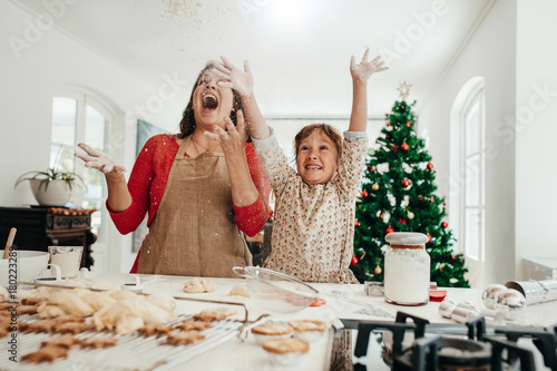 Bild auf Leinwand Mother and daughter having fun while making Christmas cookies.
