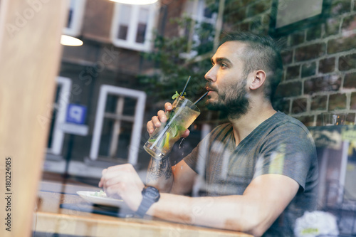 Man drinking cold fit bewerage in a cafe. photo