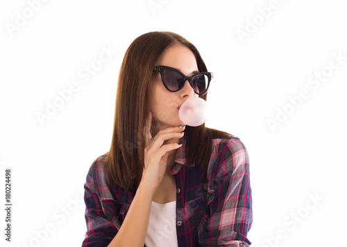 Young cute girl chews bubble gum, isolated  