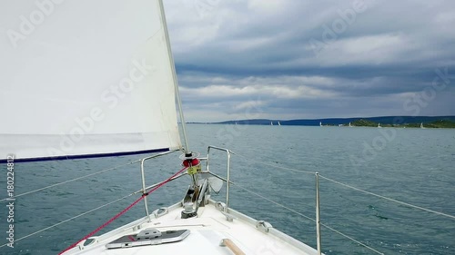 Sailing boat sailing in Croatias Adriatic sea. Closeup of boats bow with sea in background. Shot in slow motion hd. photo