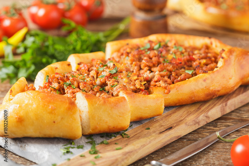 Turkish pide pizza with meat and cheese.