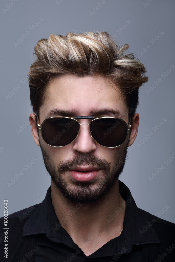 Fototapeta premium Close-up portrait of handsome stylish man in sunglasses.