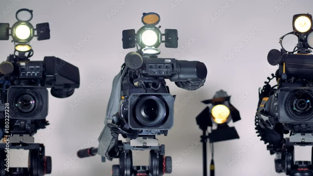 A close view on video cameras lenses and mikes. A close view on video cameras lenses and mikes.