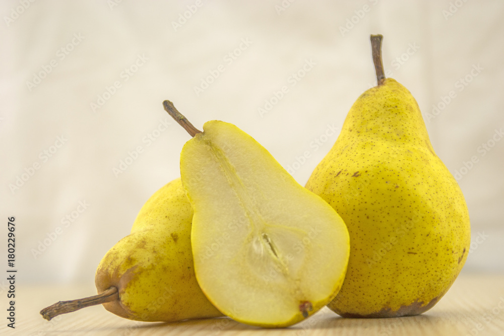 Fresh, juicy pear on a wooden base and white background color Fresh, juicy pear on a wooden base and white background color