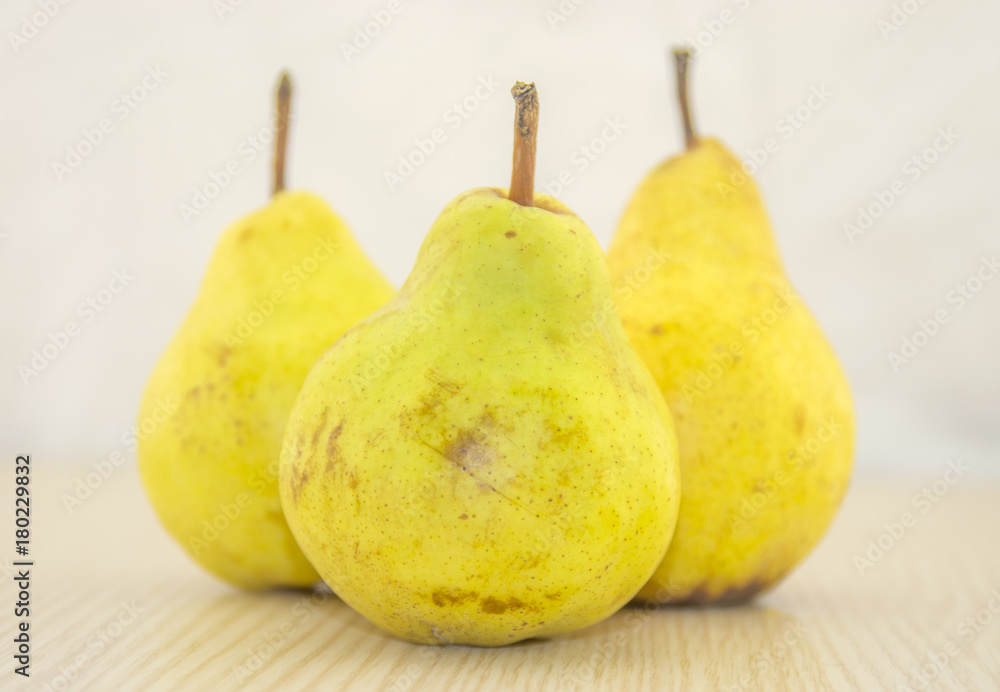 Fresh, juicy pear on a wooden base and white background color Fresh, juicy pear on a wooden base and white background color