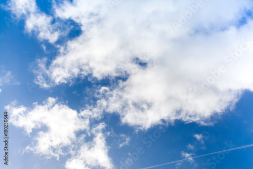 Clear blue sky with fluffy white clouds
