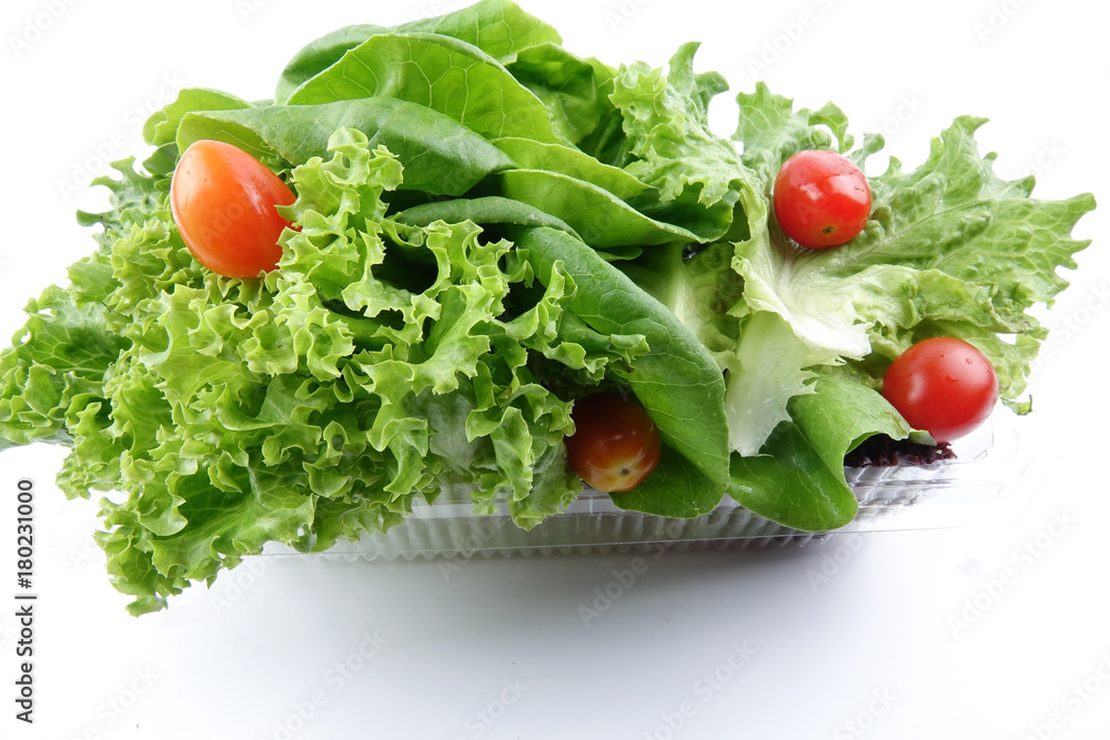 Closeup of a pile of lettuce mix for salad on a white background
