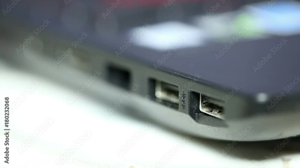 pulling the cable out of the connector on the laptop. macro pulling the cable out of the connector on the laptop. macro