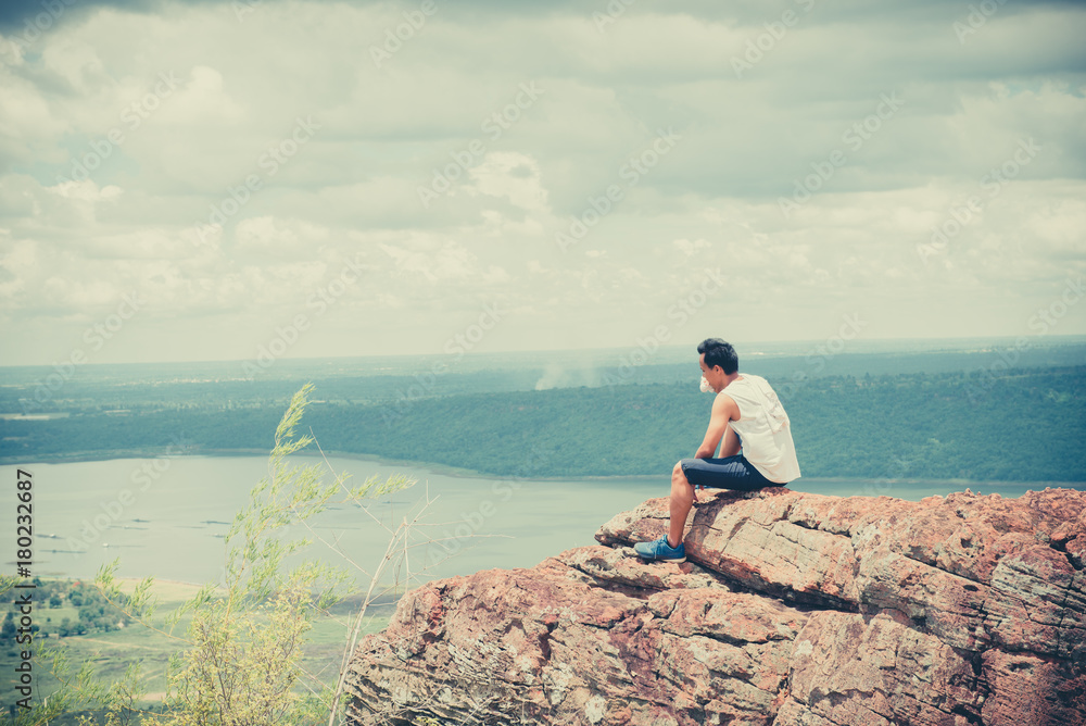 Obraz premium Asian handsome man sit alone on the mountain vintage style