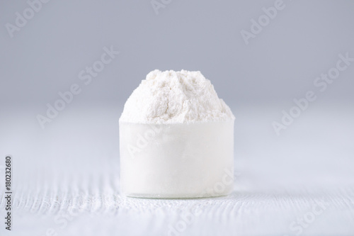 a scoop with white powder, selective focus