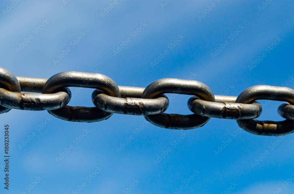 Closeup Old Steel Link Chains with Blue Sky background. Closeup Old Steel Link Chains with Blue Sky background.
