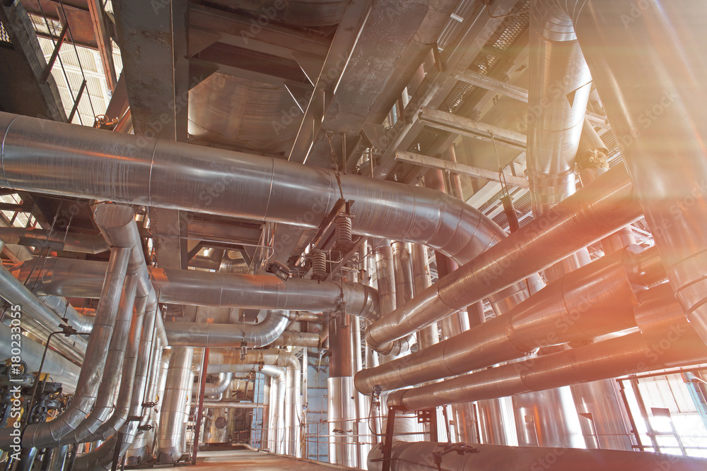 Equipment, cables and piping as found inside of a modern industrial power plant Equipment, cables and piping as found inside of a modern industrial power plant