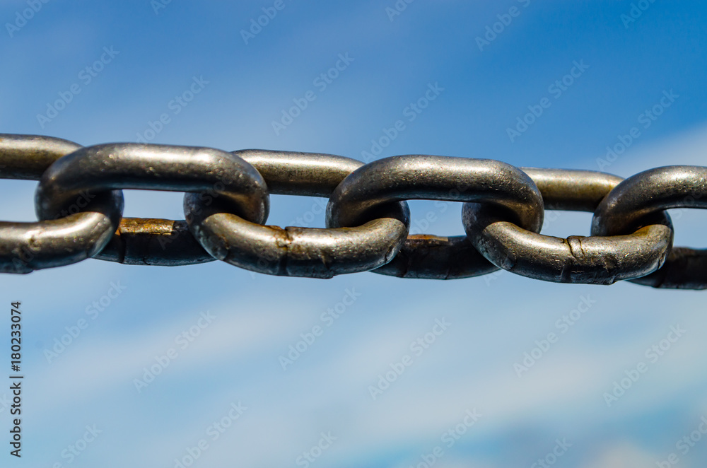 Closeup Old Steel Link Chains with Blue Sky background. Closeup Old Steel Link Chains with Blue Sky background.