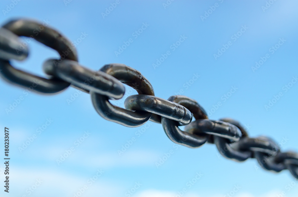 Closeup Old Steel Link Chains with Blue Sky background. Closeup Old Steel Link Chains with Blue Sky background.