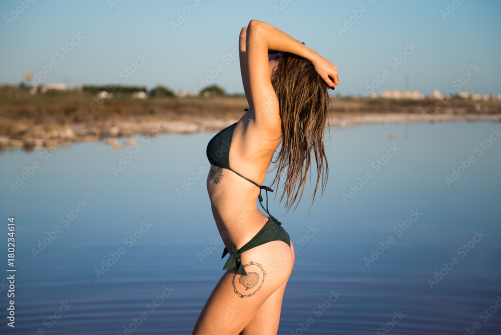 Young girl in green bikini at the beach Young girl in green bikini at the beach