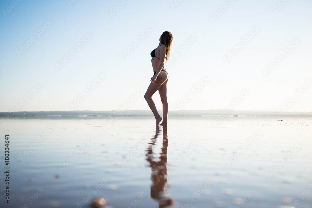 Young girl in green bikini at the beach