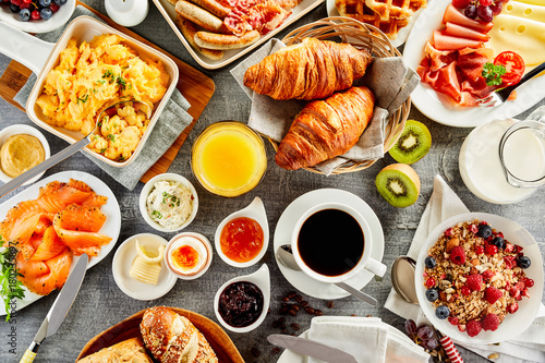 Large selection of breakfast food on a table Fototapet