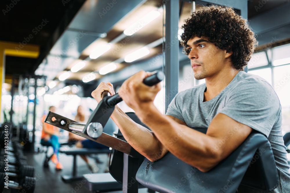 Young handsome man doing exercises in gym Young handsome man doing exercises in gym