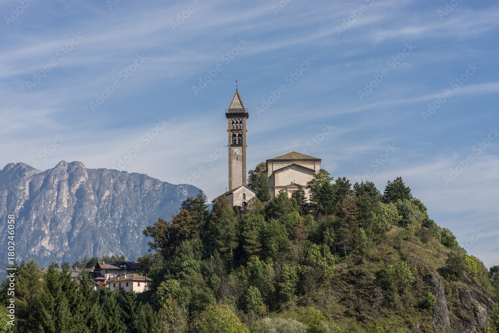 Castle on the hill landscape, mountains and peaks in background. Trentino South Tirol Castello Molina Di Fiemme, Alto Adige, Italy - Saint George Church